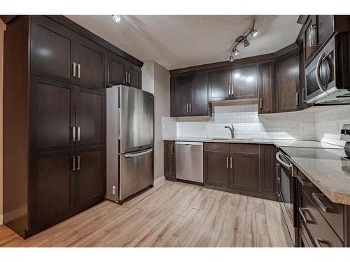 403-618 2 Avenue Nw, Calgary, AB - Indoor Photo Showing Kitchen With Stainless Steel Kitchen