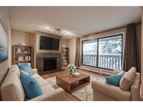 403-618 2 Avenue Nw, Calgary, AB - Indoor Photo Showing Living Room With Fireplace