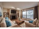 403-618 2 Avenue Nw, Calgary, AB  - Indoor Photo Showing Living Room With Fireplace 