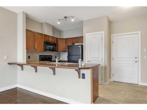 301-22 Panatella Road Nw, Calgary, AB - Indoor Photo Showing Kitchen With Double Sink