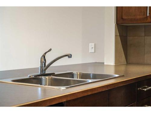 301-22 Panatella Road Nw, Calgary, AB - Indoor Photo Showing Kitchen With Double Sink