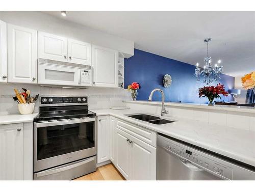 2210-11 Chaparral Ridge Drive Se, Calgary, AB - Indoor Photo Showing Kitchen With Stainless Steel Kitchen With Double Sink