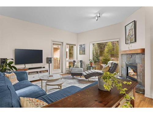 D-6 Otter Lane, Banff, AB - Indoor Photo Showing Living Room With Fireplace