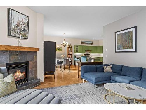 D-6 Otter Lane, Banff, AB - Indoor Photo Showing Living Room With Fireplace