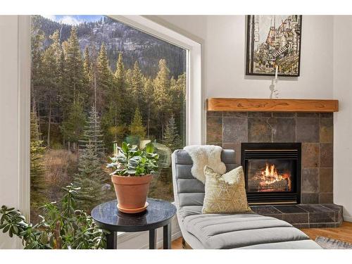 D-6 Otter Lane, Banff, AB - Indoor Photo Showing Living Room With Fireplace