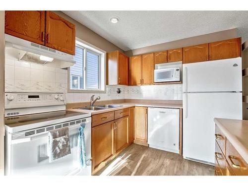 128 8 Avenue Se, High River, AB - Indoor Photo Showing Kitchen With Double Sink