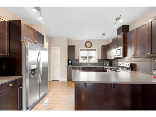 9 Belgian Street, Cochrane, AB - Indoor Photo Showing Kitchen With Double Sink