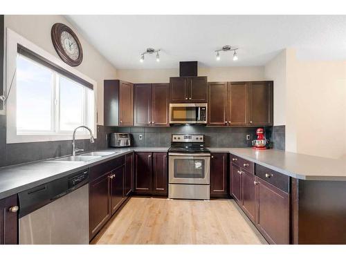 9 Belgian Street, Cochrane, AB - Indoor Photo Showing Kitchen With Stainless Steel Kitchen With Double Sink