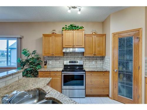 605 Woodside Court Nw, Airdrie, AB - Indoor Photo Showing Kitchen With Double Sink