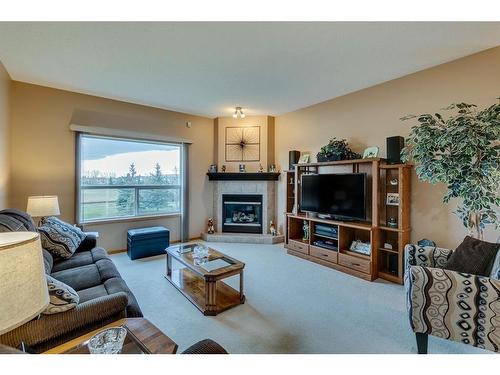 605 Woodside Court Nw, Airdrie, AB - Indoor Photo Showing Living Room With Fireplace