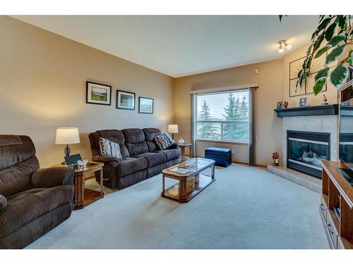 605 Woodside Court Nw, Airdrie, AB - Indoor Photo Showing Living Room With Fireplace