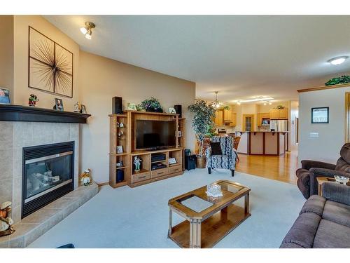 605 Woodside Court Nw, Airdrie, AB - Indoor Photo Showing Living Room With Fireplace