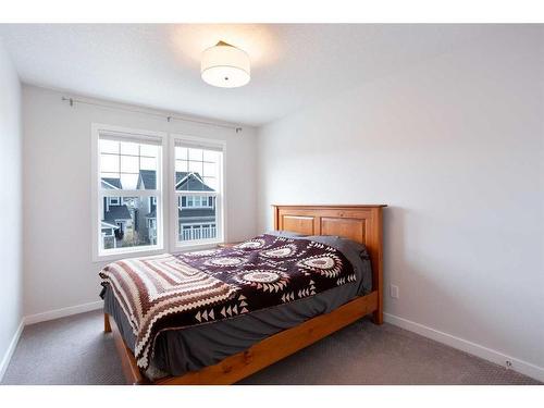 128 Sundown Way, Cochrane, AB - Indoor Photo Showing Bedroom