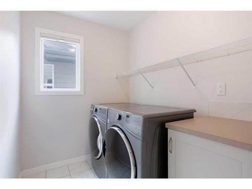 128 Sundown Way, Cochrane, AB - Indoor Photo Showing Laundry Room