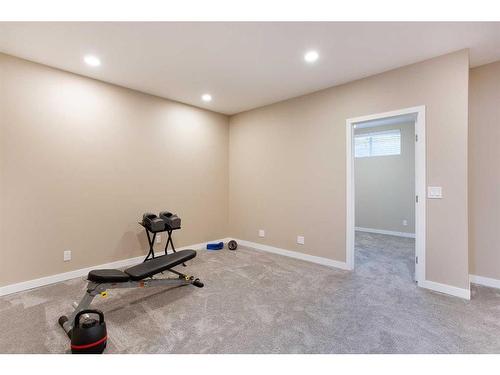 128 Sundown Way, Cochrane, AB - Indoor Photo Showing Gym Room