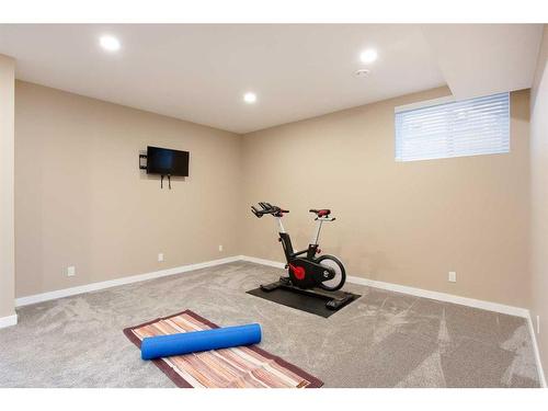 128 Sundown Way, Cochrane, AB - Indoor Photo Showing Gym Room