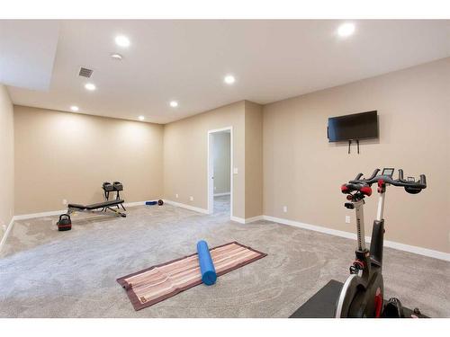 128 Sundown Way, Cochrane, AB - Indoor Photo Showing Gym Room