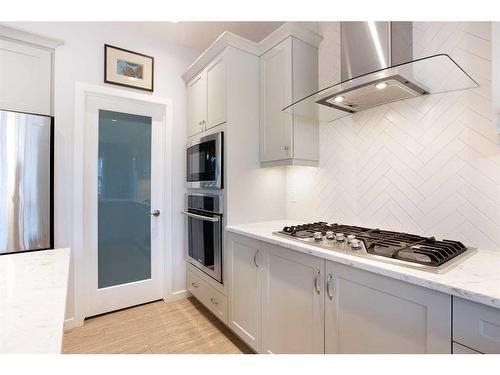 128 Sundown Way, Cochrane, AB - Indoor Photo Showing Kitchen With Upgraded Kitchen