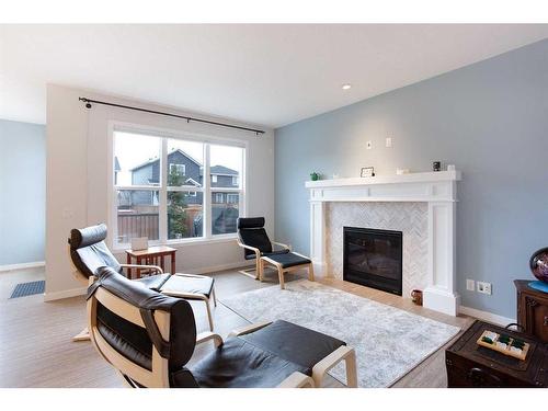 128 Sundown Way, Cochrane, AB - Indoor Photo Showing Living Room With Fireplace