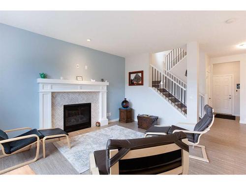 128 Sundown Way, Cochrane, AB - Indoor Photo Showing Living Room With Fireplace