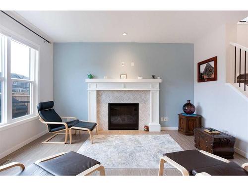 128 Sundown Way, Cochrane, AB - Indoor Photo Showing Living Room With Fireplace