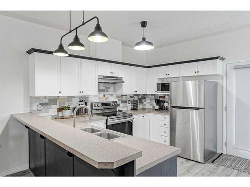 703-2001 Luxstone Boulevard Sw, Airdrie, AB - Indoor Photo Showing Kitchen With Stainless Steel Kitchen With Double Sink