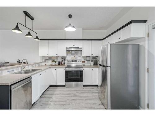 703-2001 Luxstone Boulevard Sw, Airdrie, AB - Indoor Photo Showing Kitchen With Stainless Steel Kitchen With Double Sink