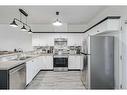 703-2001 Luxstone Boulevard Sw, Airdrie, AB  - Indoor Photo Showing Kitchen With Stainless Steel Kitchen With Double Sink 