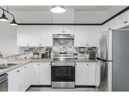 703-2001 Luxstone Boulevard Sw, Airdrie, AB - Indoor Photo Showing Kitchen With Double Sink