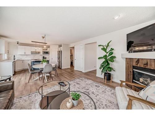 154 Rockbluff Close Nw, Calgary, AB - Indoor Photo Showing Living Room With Fireplace