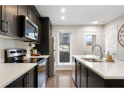 214-338 Seton Circle Se, Calgary, AB - Indoor Photo Showing Kitchen With Double Sink With Upgraded Kitchen