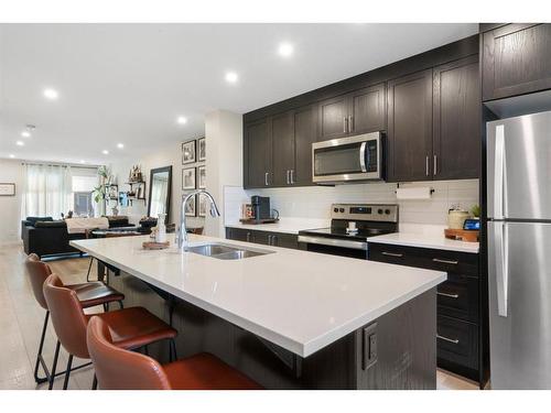 214-338 Seton Circle Se, Calgary, AB - Indoor Photo Showing Kitchen With Stainless Steel Kitchen With Double Sink With Upgraded Kitchen