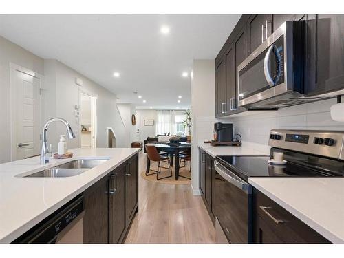 214-338 Seton Circle Se, Calgary, AB - Indoor Photo Showing Kitchen With Stainless Steel Kitchen With Double Sink With Upgraded Kitchen