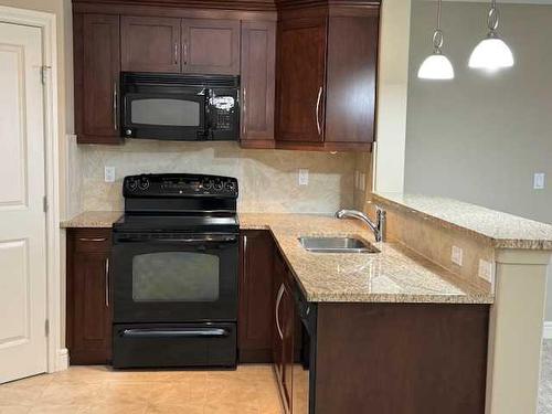 1239-2330 Fish Creek Boulevard Sw, Calgary, AB - Indoor Photo Showing Kitchen With Double Sink