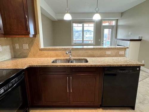 1239-2330 Fish Creek Boulevard Sw, Calgary, AB - Indoor Photo Showing Kitchen With Double Sink