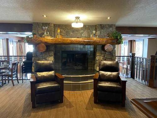 1239-2330 Fish Creek Boulevard Sw, Calgary, AB - Indoor Photo Showing Living Room With Fireplace