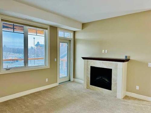 1239-2330 Fish Creek Boulevard Sw, Calgary, AB - Indoor Photo Showing Other Room With Fireplace