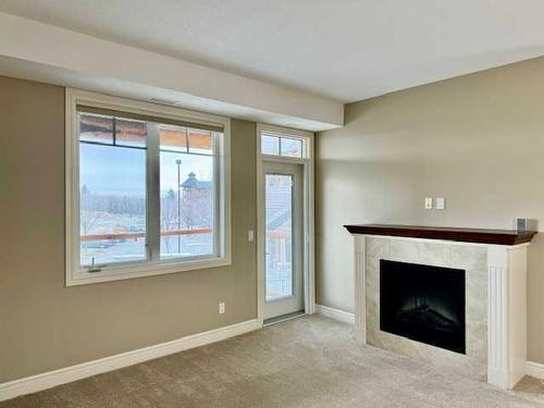 1239-2330 Fish Creek Boulevard Sw, Calgary, AB - Indoor Photo Showing Living Room With Fireplace