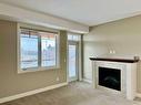 1239-2330 Fish Creek Boulevard Sw, Calgary, AB  - Indoor Photo Showing Living Room With Fireplace 