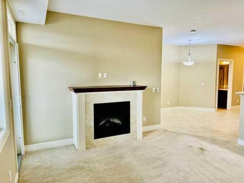 1239-2330 Fish Creek Boulevard Sw, Calgary, AB - Indoor With Fireplace