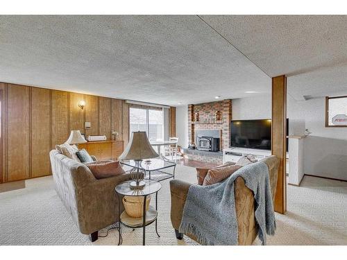 84 Range Way Nw, Calgary, AB - Indoor Photo Showing Living Room With Fireplace