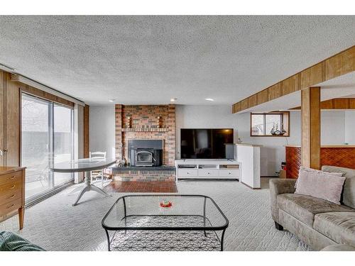 84 Range Way Nw, Calgary, AB - Indoor Photo Showing Living Room With Fireplace