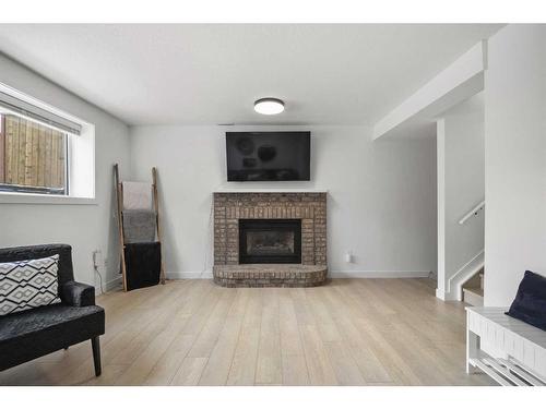 59 River Rock Way Se, Calgary, AB - Indoor Photo Showing Living Room With Fireplace