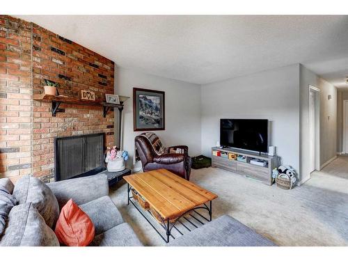 5202 Bowness Road Nw, Calgary, AB - Indoor Photo Showing Living Room With Fireplace