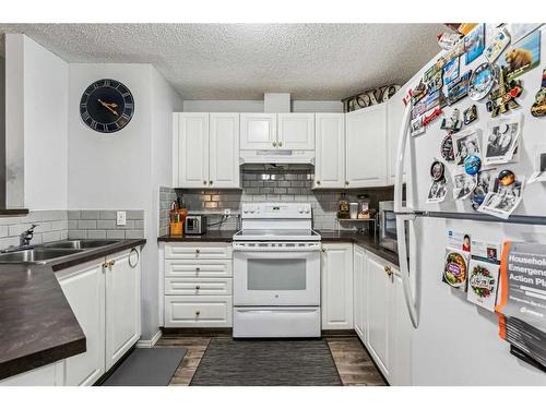 311-1000 Somervale Court Sw, Calgary, AB - Indoor Photo Showing Kitchen With Double Sink