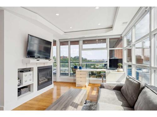 808-205 Riverfront Avenue Sw, Calgary, AB - Indoor Photo Showing Living Room With Fireplace