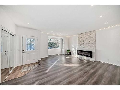 908 Riverbend Drive Se, Calgary, AB - Indoor Photo Showing Living Room With Fireplace