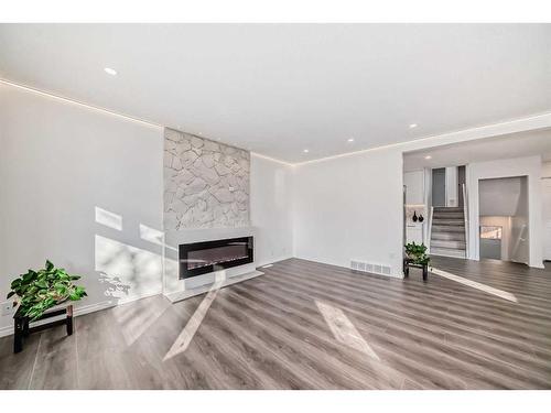 908 Riverbend Drive Se, Calgary, AB - Indoor Photo Showing Living Room With Fireplace