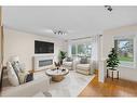 29 Crystal Shores Crescent, Okotoks, AB  - Indoor Photo Showing Living Room With Fireplace 