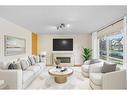 29 Crystal Shores Crescent, Okotoks, AB  - Indoor Photo Showing Living Room With Fireplace 